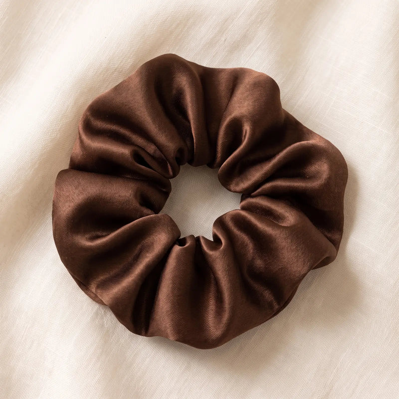 Brown satin scrunchie on cream fabric