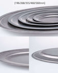 Stack of VINTAGE INOX oval plates in stainless steel featuring five sizes from 196mm to 560mm, showcasing durable and chic design.