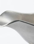 Close-up of a vintage stainless steel INOX sauce pot lip with a chic, durable design made in Japan.