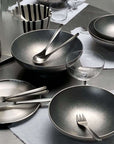 Host's Choice bundle: Kyoto bowls, steel plates, cutlery and napkins on a table