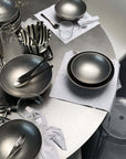 Host's Choice bundle for four: Kyoto steel bowls, plates, cutlery and cups laid on a table