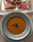 Artisan Pasta Plate filled with pumpkin soup, top view