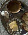Shoreline butter knife with shell handle on a steel tray with butter, bread and coffee