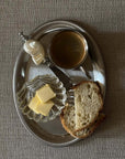 Clara Glass Shell Dish with butter on a breakfast tray, top view