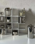 Stello Countertop Grid Shelf holding a French press, steel cups and cans