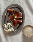 Matte Stainless Steel Oval Plate with figs and toast beside a latte