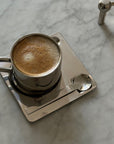 Tazza di caffè in acciaio con piattino quadrato e cucchiaio
