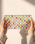 Hands holding the Tessera hand-painted rectangular platter against a sunlit wall