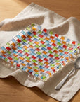 Tessera square platter with a spoon on linen, seen from above