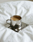 Venice Mirror Cup with a latte on its square saucer, from the Spring Bundle