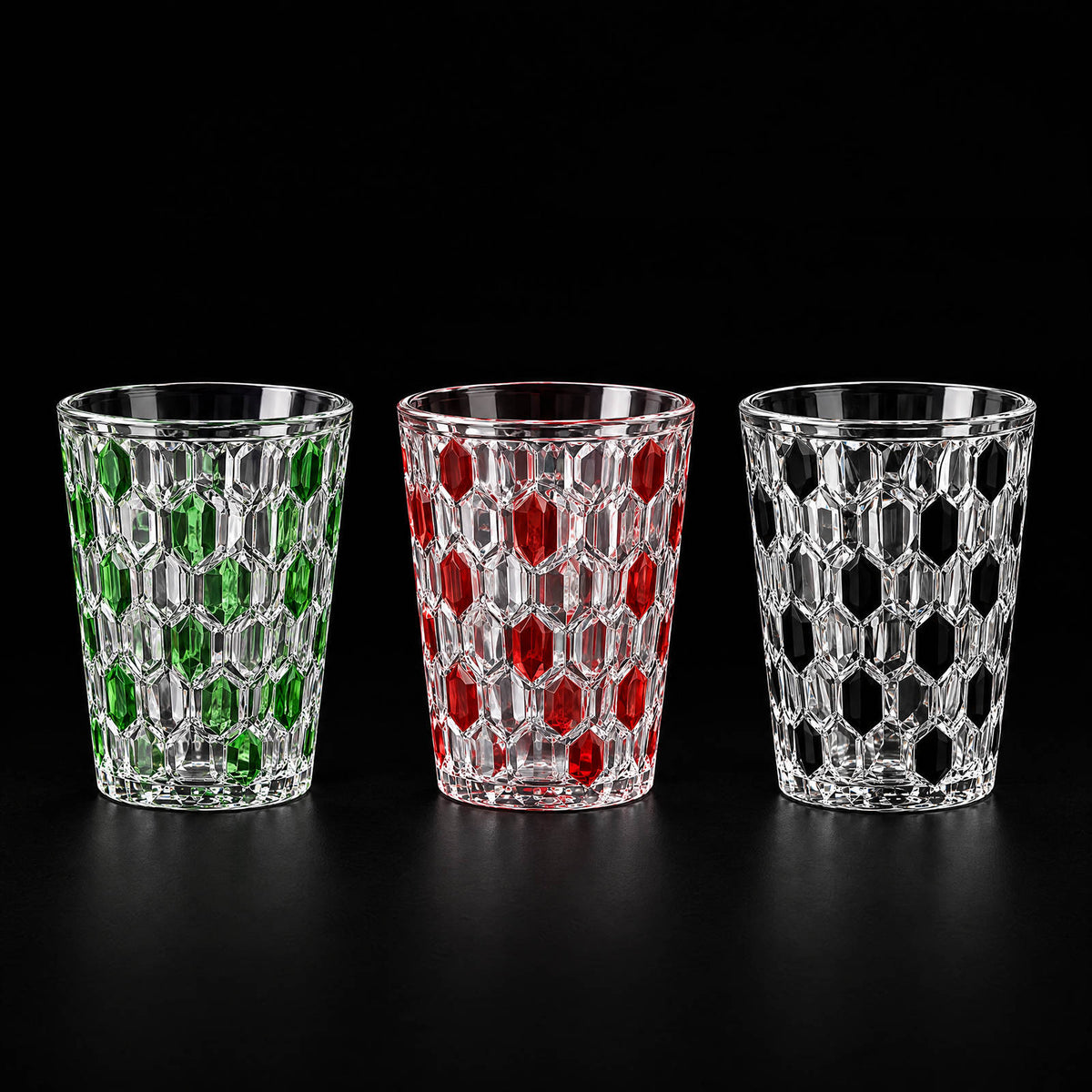 Green, red and black Vetra Raindrop hand-painted glasses side by side on a black background
