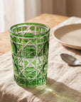 Green Vetra Lattice glass filled with water on a linen tablecloth
