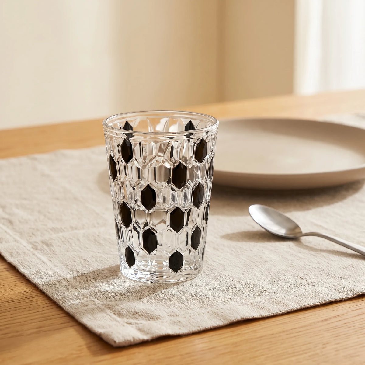 Black Vetra Raindrop glass with water on a linen tablecloth