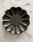 Rinka Plate 14cm black porcelain with floral design, handcrafted in Japan, elegant and microwave safe, on a marble background.