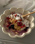 Rinka Bowl 16cm with yogurt and berries, handcrafted by Kaneko Kohyo, showcasing its flower shape and elegance on a table setting.
