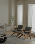 Modern living room with two teak wood Scissors Chairs showcasing sleek design, comfort, and style.
