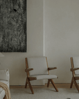 Elegant Scissors Chair with teak wood frames in minimalist living room setting, featuring comfortable lounge design.