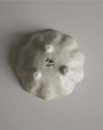 Underside view of Rinka Bowl 10cm by Kaneko Kohyo, showcasing delicate porcelain craftsmanship with three small support stands. Made in Japan.