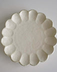 Elegant Rinka Plate 24cm in porcelain, handcrafted in Japan, featuring a timeless design with scalloped edges. Microwave and dishwasher safe.