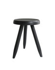 Black Meribel Stool made from imported teak wood with alpine-inspired design and manual polishing, perfect for architectural elegance.