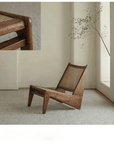 Kangaroo Chair featuring a Z-shaped design with rattan seat, solid wood frame, and thin painted surface in a minimalist interior.