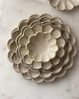 Handcrafted Rinka porcelain plates with flower petal design, showcasing Japanese craftsmanship by Kaneko Kohyo.