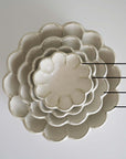Nested Rinka porcelain bowls in flower shape, sizes labeled 10cm, 12cm, 16cm, and 21cm, from the Rinka Collection by Kaneko Kohyo.