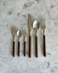 Elegant Rosewood cutlery set with unique natural wood handles displayed on a marble surface.