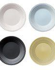 Four Storia Plates 24cm in white, blue, black, and yellow with elegant lace edges and lacquer finish, made from porcelain.