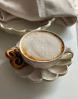 Rinka Soup Cup by Kaneko Kohyo with coffee on porcelain saucer, showcasing handcrafted flower shape design, perfect for table setting.