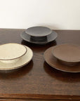Collection of Rila Ivory 11.5cm porcelain plates by Kaneko Kohyo, featuring a textured, warm finish; perfect with Rila Mugs.
