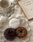 Rinka Mug & Plate Set with morning coffee, assorted donuts, and a book on a textured tablecloth