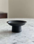 Tall Plate by Yoshida Pottery on marble table, designed with nature-inspired patterns for elegant table settings.