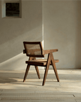 Chandigarh chair in teak and rattan with wabi-sabi design, showcasing minimalism and intricate carvings, perfect for peaceful living spaces.
