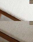 White and beige linen cushions on wood-mounted dining chair showcasing fabric texture and color options.