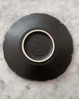 Yukiwa Plate by Yoshida Pottery showcasing nature-inspired design on a sleek surface, perfect for elegant table settings.