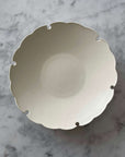 Yukiwa Plate by Yoshida Pottery with nature-inspired design on a marble surface. Elegant ceramic dishware by Masakazu Yoshida.