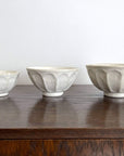 Handcrafted Rinka medium soup bowls in white porcelain, showcasing elegant flower shapes, perfect for enhancing table settings.