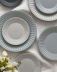 Elegant Storia Plates 27cm with soft lace edge design, showcasing nostalgia and sophistication, arranged on a tablecloth.